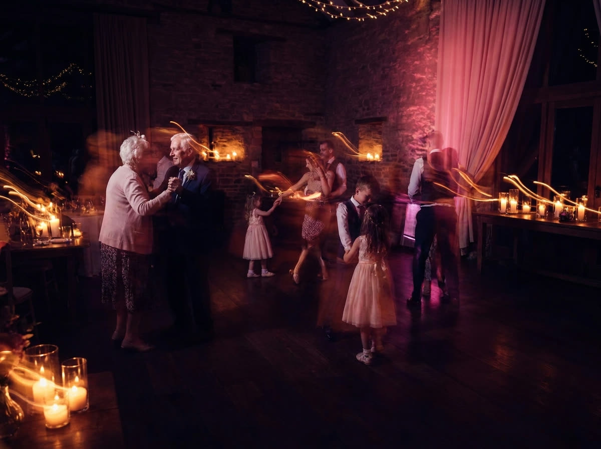 Wedding guests of every generation dancing in a bright ballroom